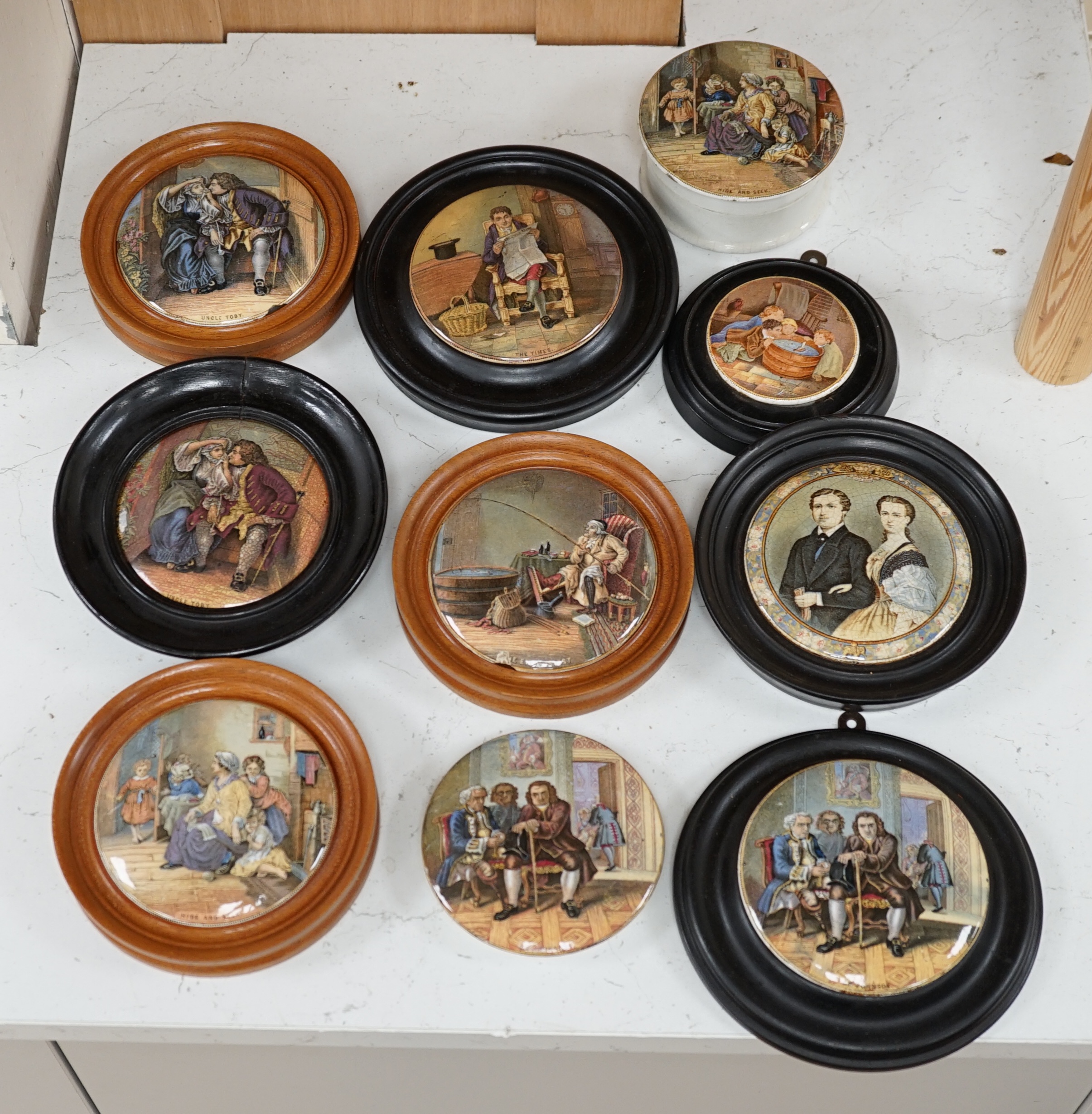 Nine 19th century framed pot lids including ‘Hide and Seek’ and ‘Uncle Toby’ and a jar and cover, largest overall 16cm diameter. Condition - fair to good